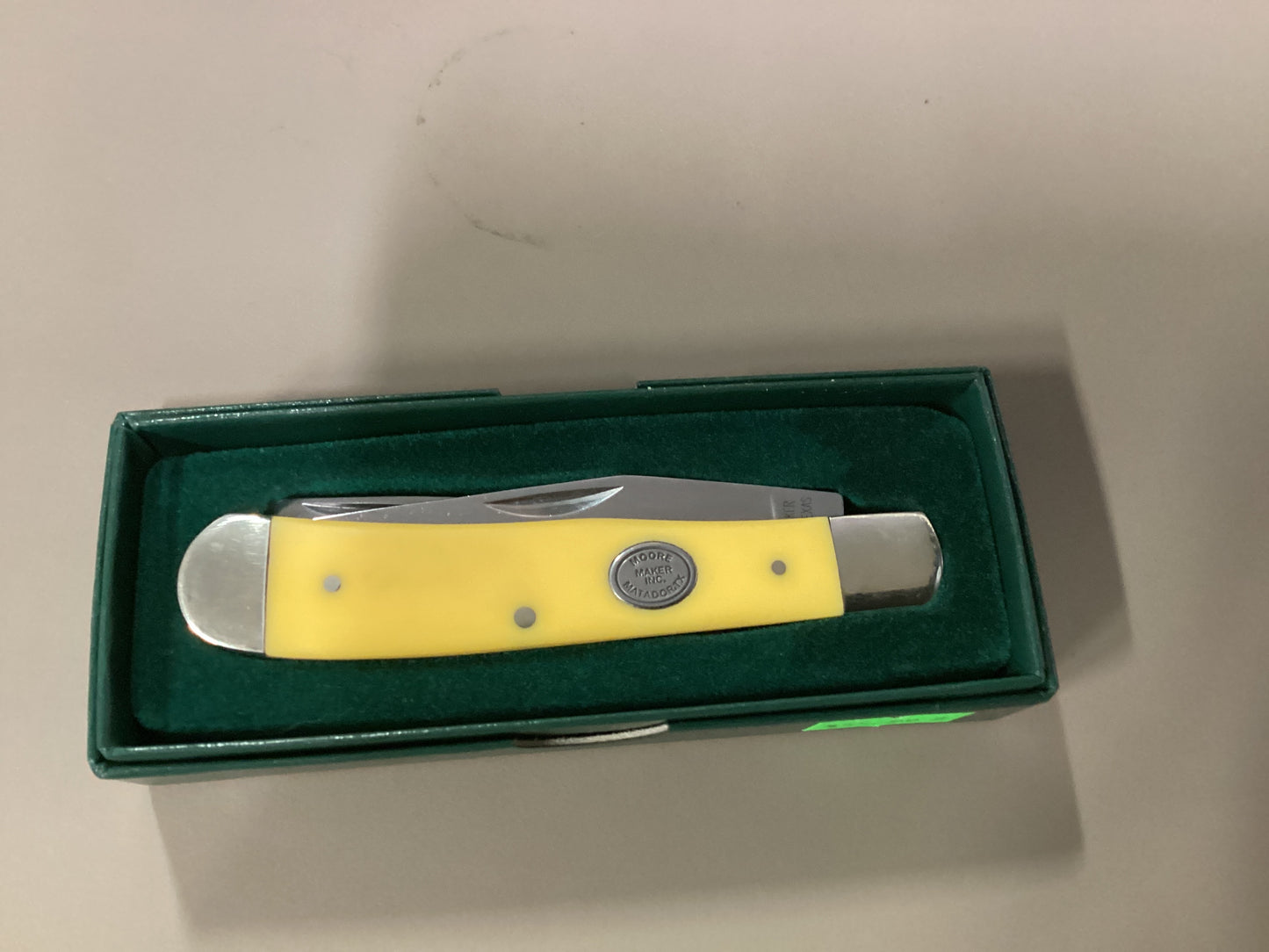 Moore Maker yellow delrin oval badge knife
